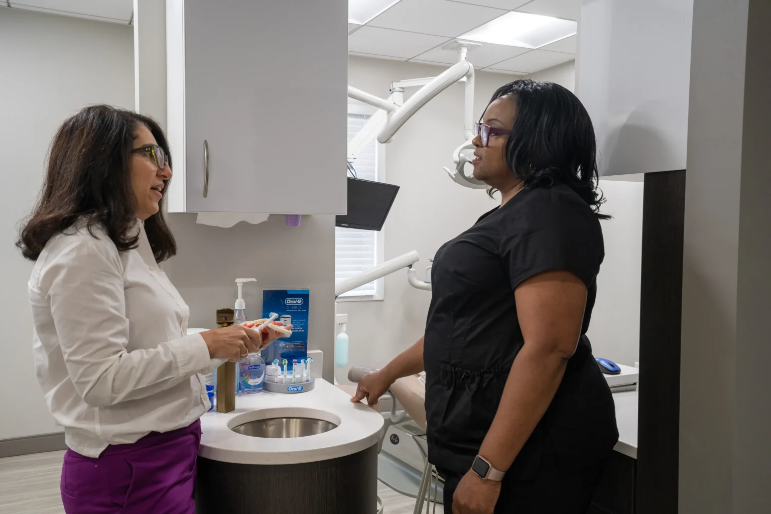 Dentist Discussing Treatment Options With Patient In Dental Office