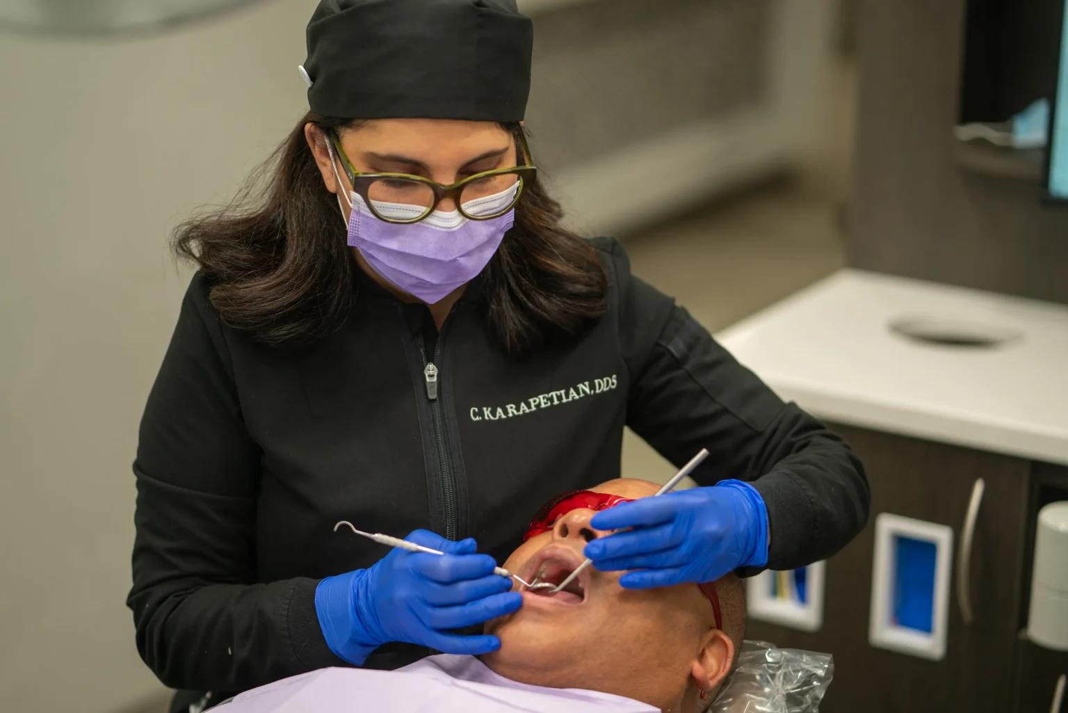 Dentist Performing Oral Examination During Patient Appointment