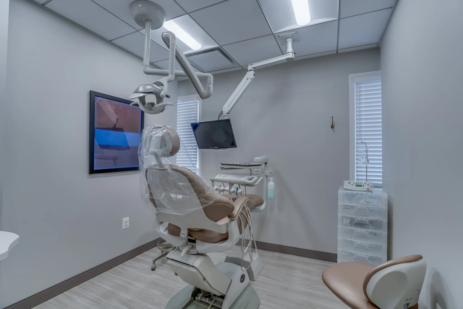 Modern Dental Treatment Room With Patient Chair And Equipment